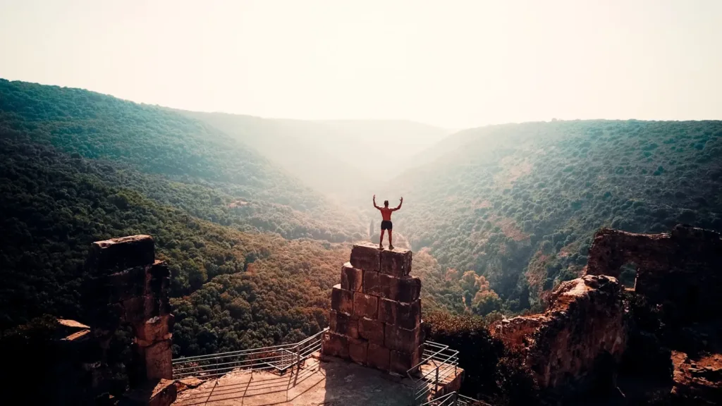 person-standing-on-brown-concrete building during daytime