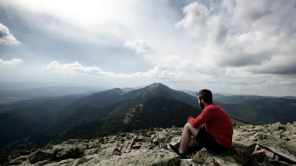 man-sitting-on-rocks