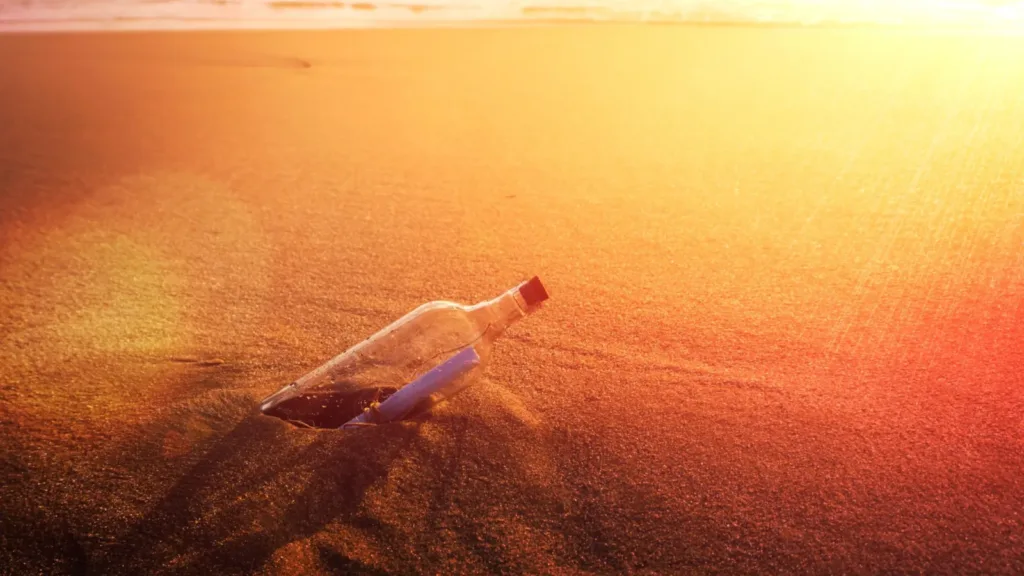 message-in-a-bottle-on-the-sandy-shore-sunset.