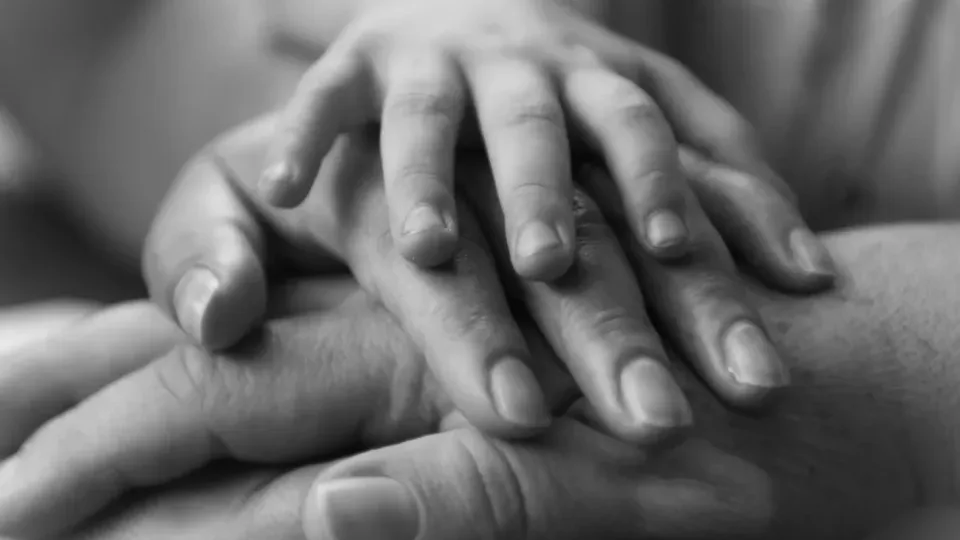 A-touching-black-and-white-photo-of-hands-conveying-family-unity-and-love