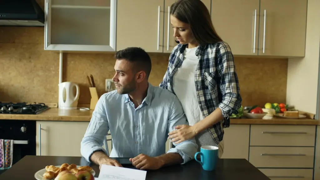 Couple-sitting-at-kitchen-table-with-pastries